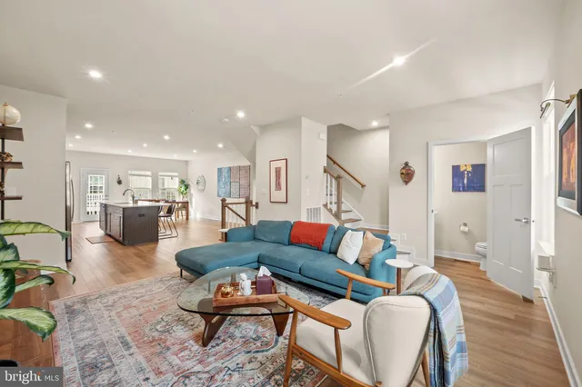 a living room with furniture and kitchen view