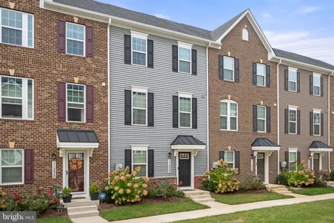a front view of a house with yard and green space