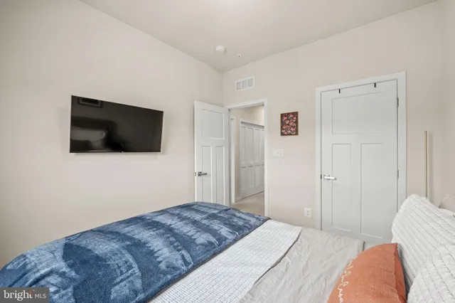 a bedroom with a bed and a flat screen tv