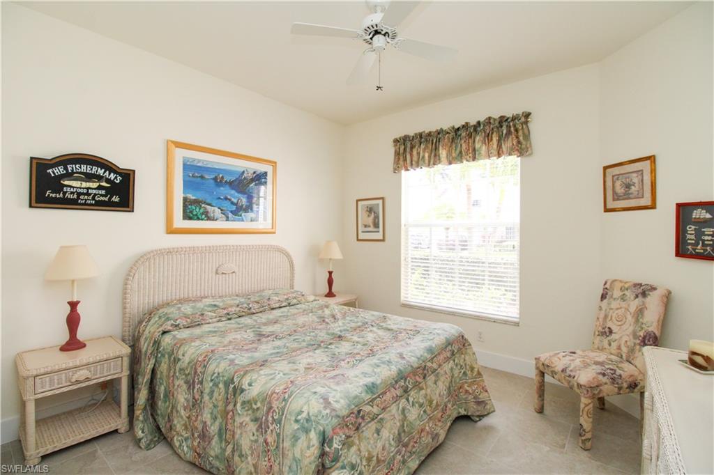 317 Sunrise Cay, Unit 103 Naples, FL 34114 - Photo 25 of 50 a bedroom with a bed and a window
