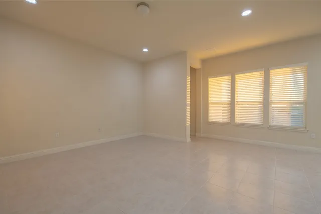 an empty room with windows and closet