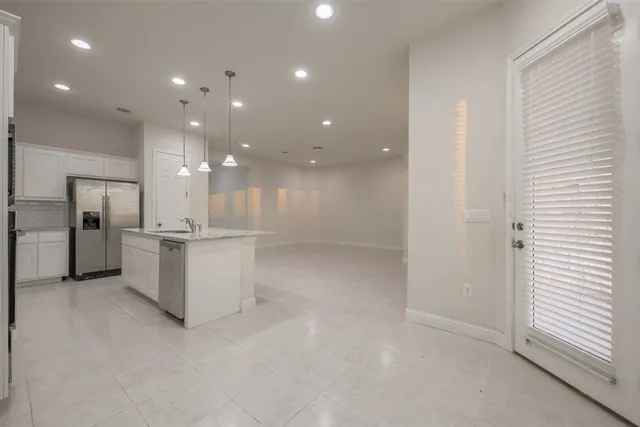 a view of kitchen with white cabinets