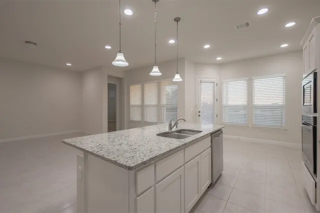 a bathroom with a granite countertop sink a toilet and a bathtub