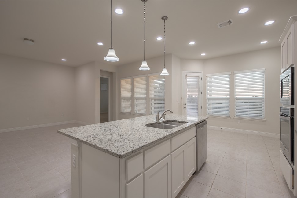 14928 Iveans Way Austin, TX 78717 - Photo 19 of 28 a bathroom with a granite countertop sink a toilet and a bathtub