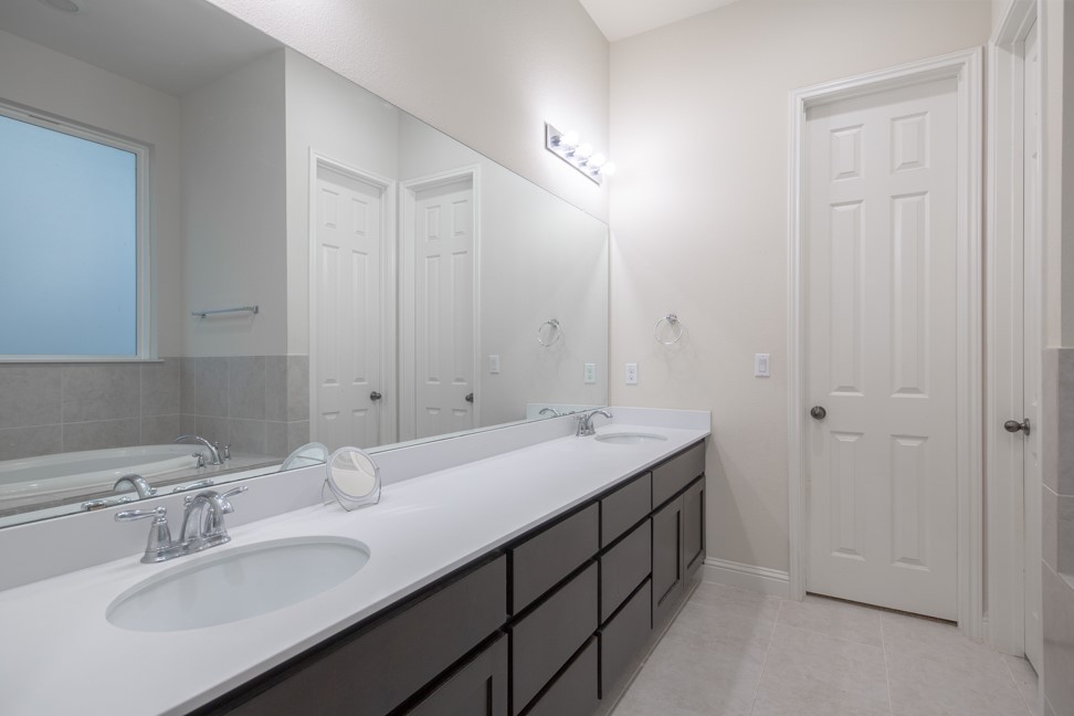 14928 Iveans Way Austin, TX 78717 - Photo 23 of 28 a spacious bathroom with a double vanity sink and a mirror