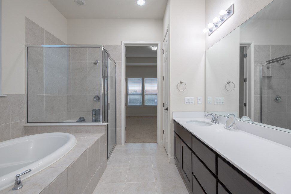 14928 Iveans Way Austin, TX 78717 - Photo 25 of 28 a bathroom with a tub sink shower and two mirror