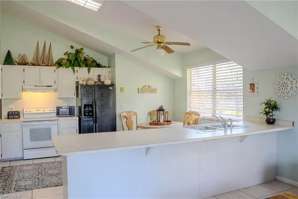 a very nice looking dining room with a window and chandelier