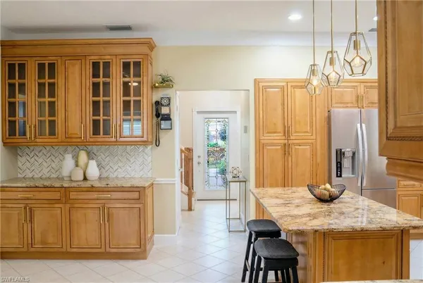 a kitchen with stainless steel appliances granite countertop a sink a counter and kitchen view