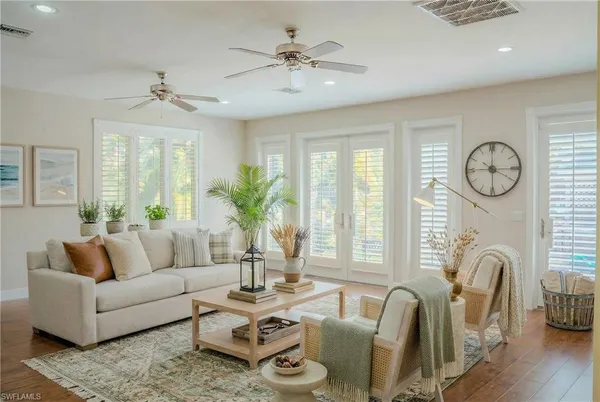 a living room with furniture a window and a table