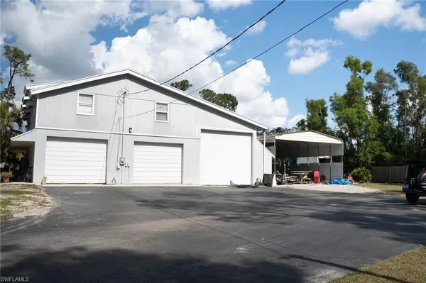 a view of building with car parked