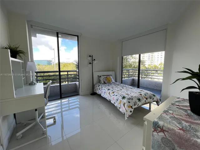 a bedroom with a bed and large window
