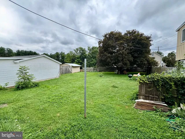 a backyard of a house with lots of green space and lake view