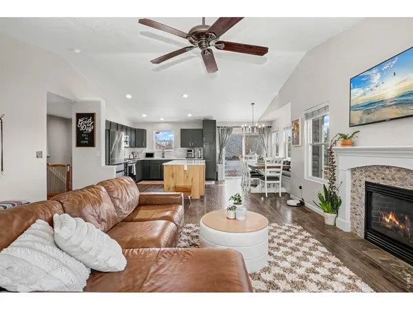 a living room with furniture kitchen view and a fireplace