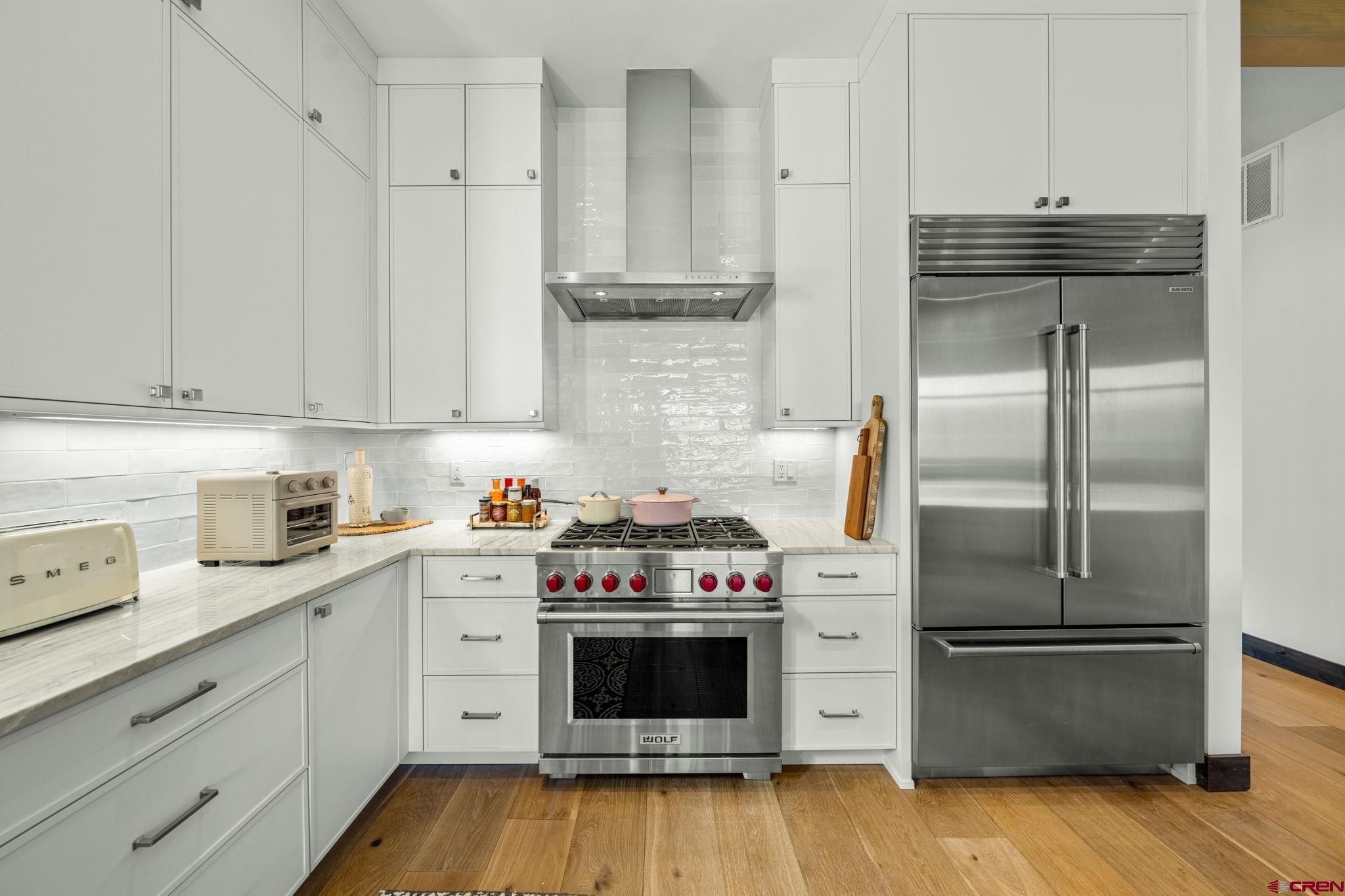 136 Outlaw Drive, Unit 3B Durango, CO 81301 - Photo 23 of 45 a kitchen with cabinets stainless steel appliances and wooden floor