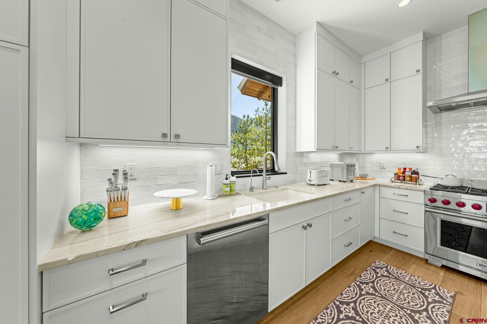136 Outlaw Drive, Unit 3B Durango, CO 81301 - Photo 25 of 45 a kitchen with stainless steel appliances white cabinets and a window