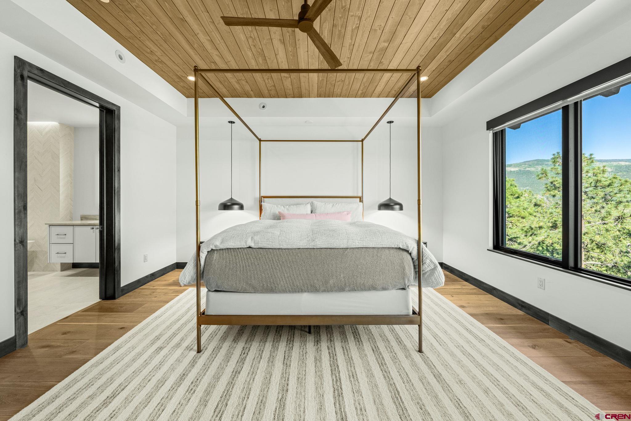 136 Outlaw Drive, Unit 3B Durango, CO 81301 - Photo 28 of 45 a bed sitting in a spacious bedroom next to a window