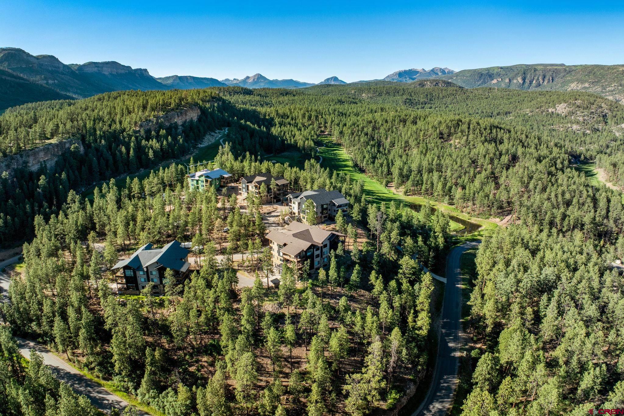 136 Outlaw Drive, Unit 3B Durango, CO 81301 - Photo 3 of 45 a view of a lush green field with mountains in the background