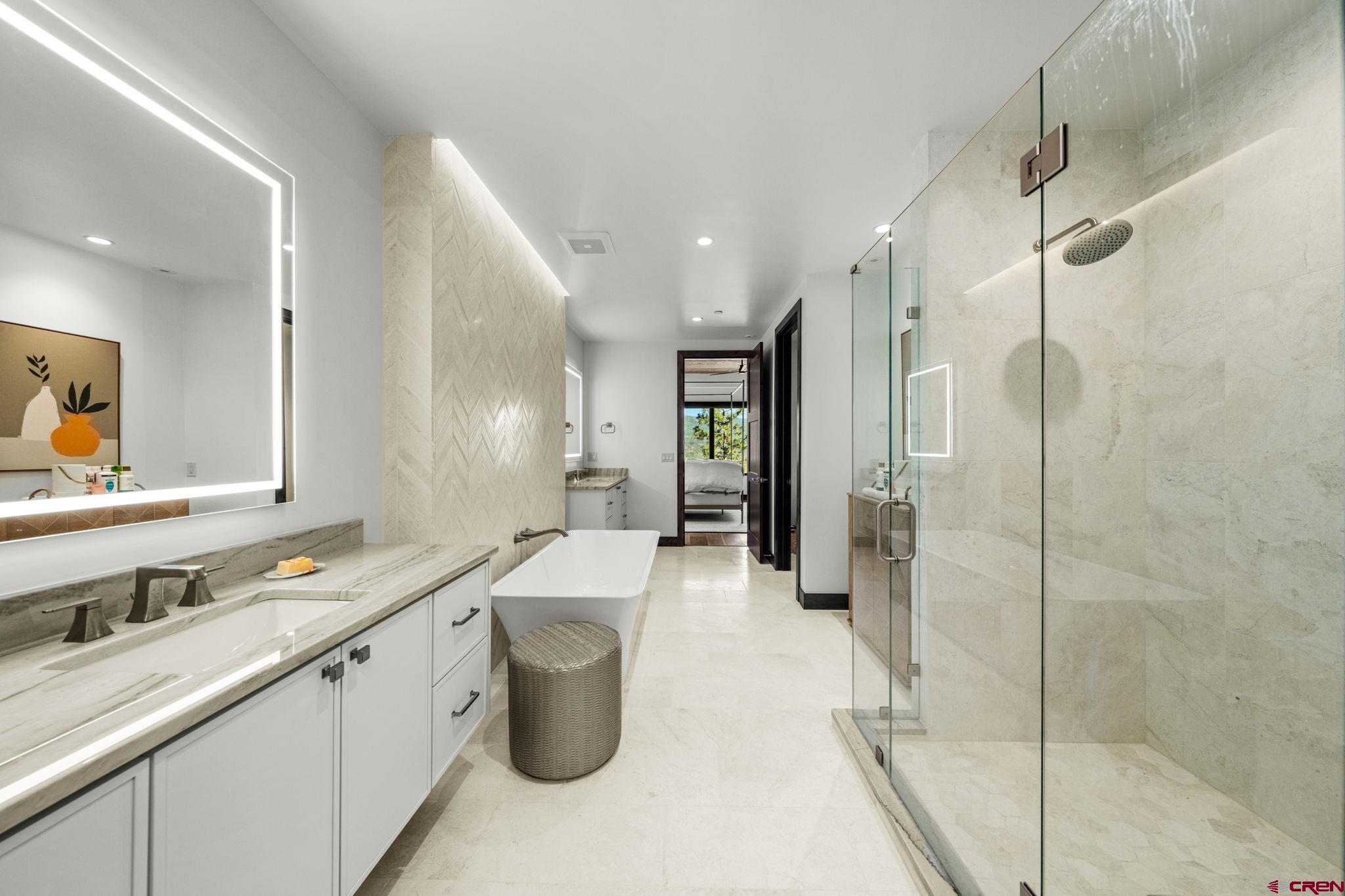 136 Outlaw Drive, Unit 3B Durango, CO 81301 - Photo 32 of 45 a large bathroom with a granite countertop sink mirror and shower