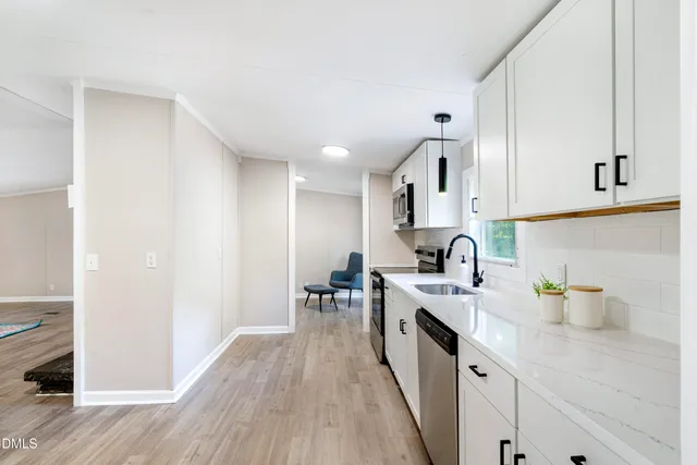 a kitchen with a sink a stove and cabinets