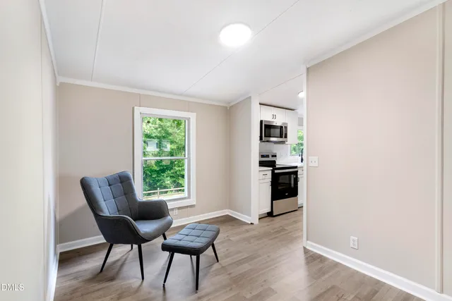 a view of a livingroom with furniture and a window