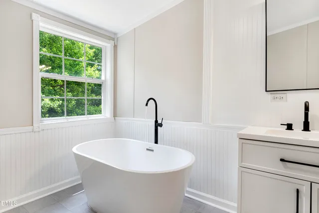 a bathroom with a sink and a window