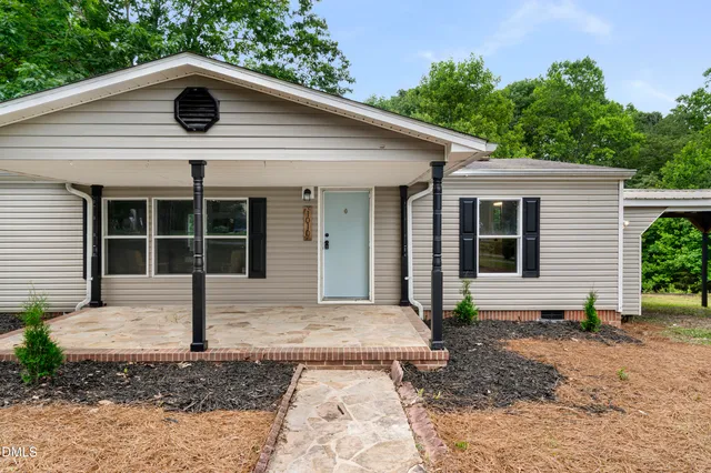 a view of a house with a yard and plants