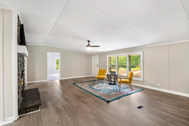 a living room with dining table and a table