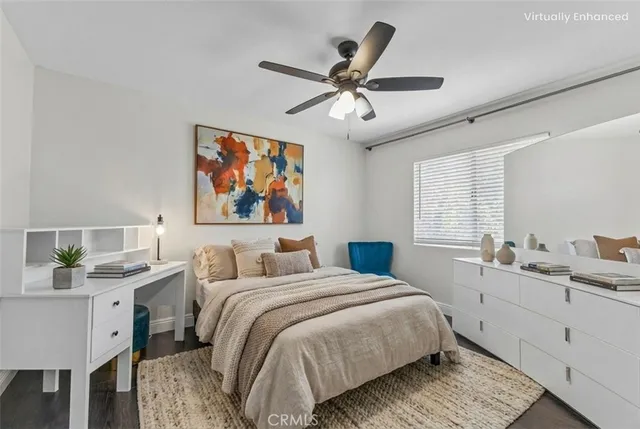 a bedroom with a large bed a chandelier and a window