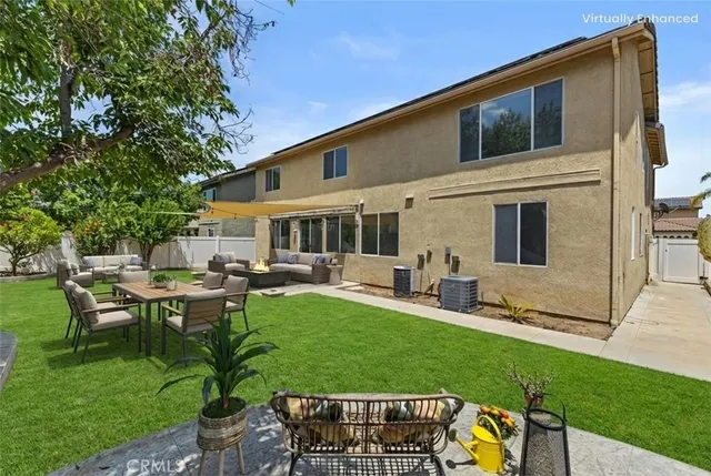 a view of a house with backyard sitting area and garden