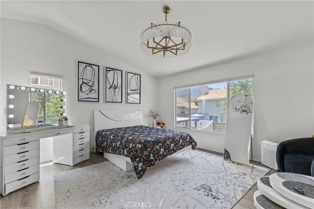 a bedroom with a bed dresser and a window