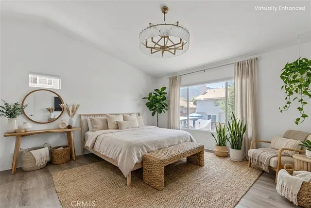 a bed room with a bed and a chandelier