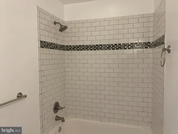 a bathroom with a bathtub and shower