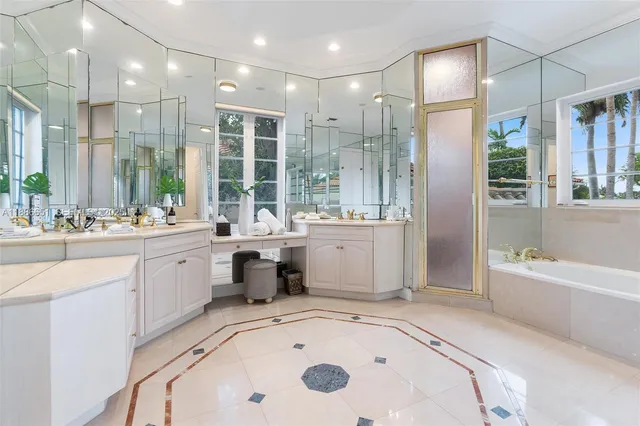 a bathroom with double vanity sinks and a mirror