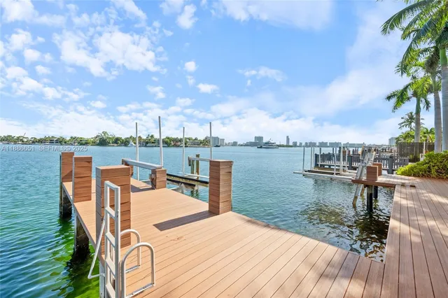 a view of a white house with a yard and plants