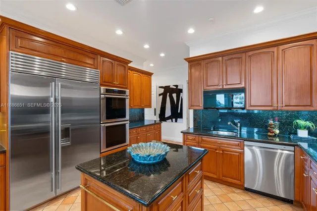 a kitchen with stainless steel appliances granite countertop sink stove and cabinets