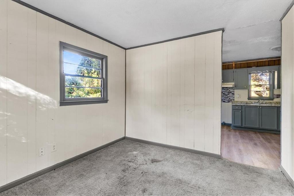 50 Evelyn Road Covington, GA 30016 - Photo 13 of 23 a view of a kitchen with a fridge and wooden floor