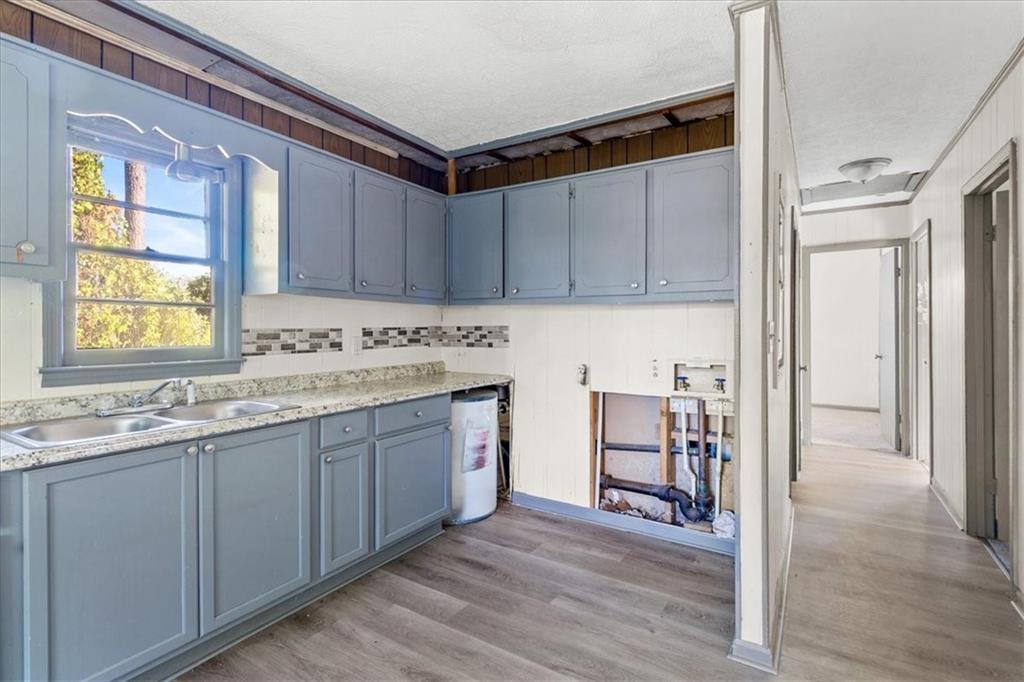 50 Evelyn Road Covington, GA 30016 - Photo 18 of 23 a kitchen with granite countertop a sink cabinets and wooden floor
