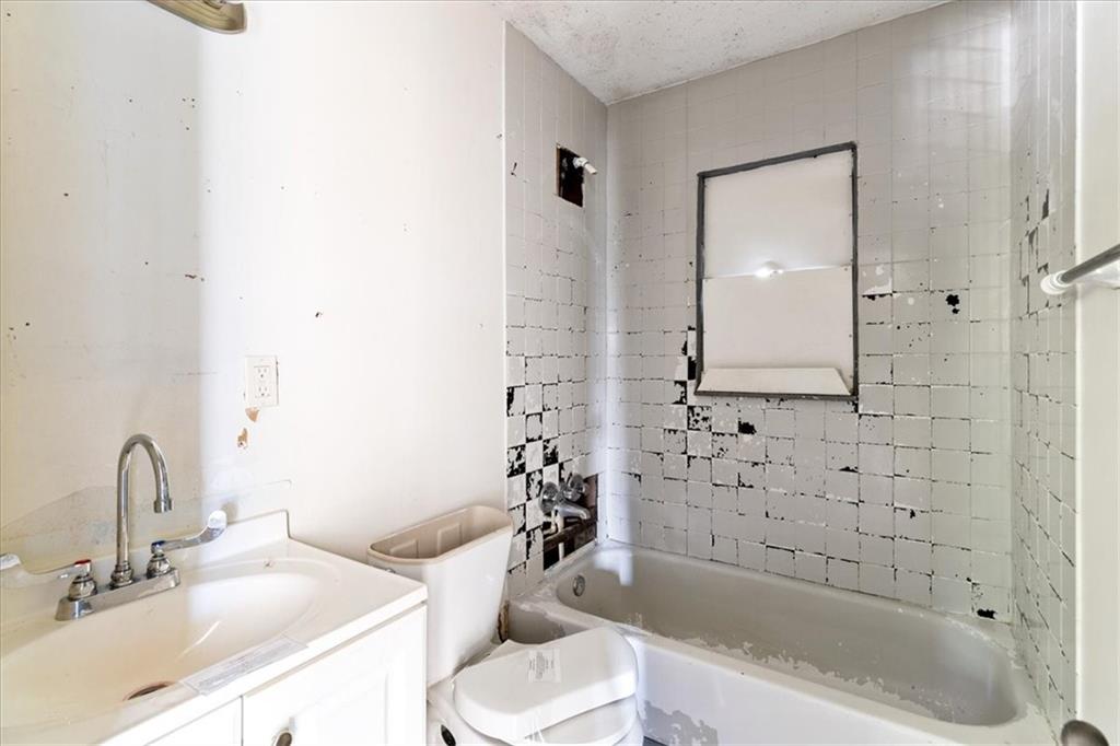 50 Evelyn Road Covington, GA 30016 - Photo 22 of 23 a bathroom with a bathtub sink mirror vanity and toilet