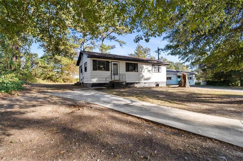 50 Evelyn Road Covington, GA 30016 - Photo 4 of 23 a view of a house with a backyard