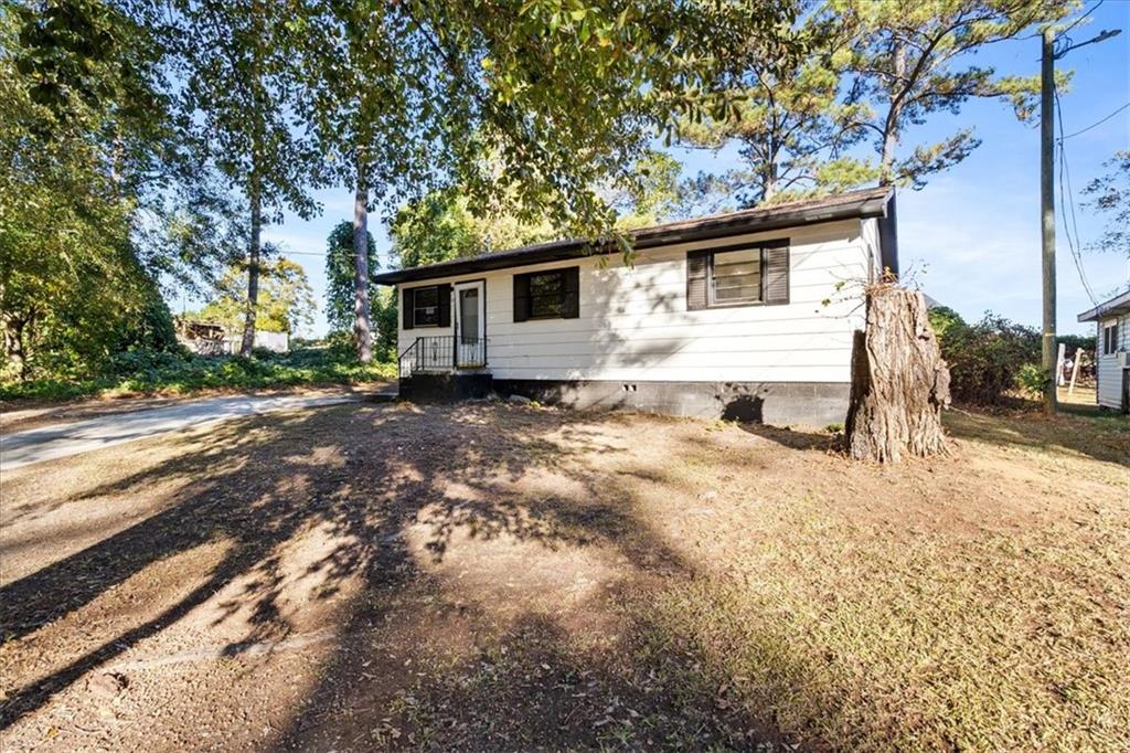 50 Evelyn Road Covington, GA 30016 - Photo 5 of 23 a white house that has a tree in front of it