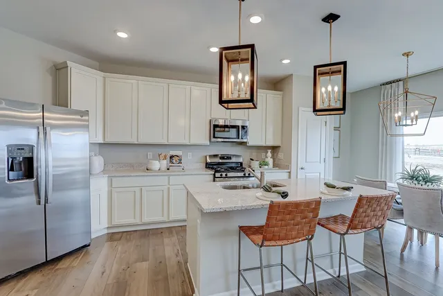 a kitchen with kitchen island granite countertop a sink cabinets and window