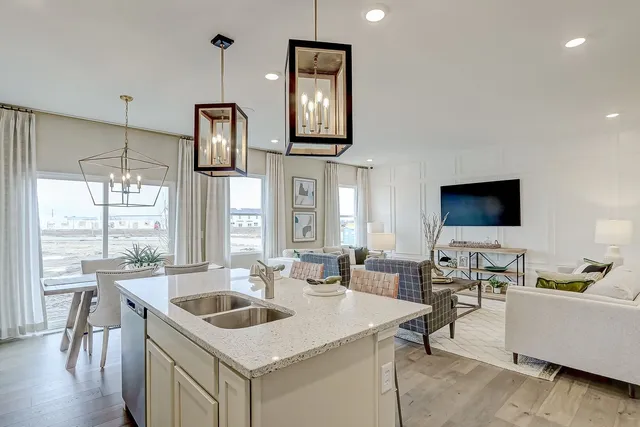 a kitchen with stainless steel appliances granite countertop a microwave a stove a sink and a refrigerator