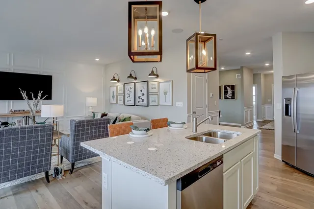 a kitchen with stainless steel appliances granite countertop white cabinets and a stove top oven