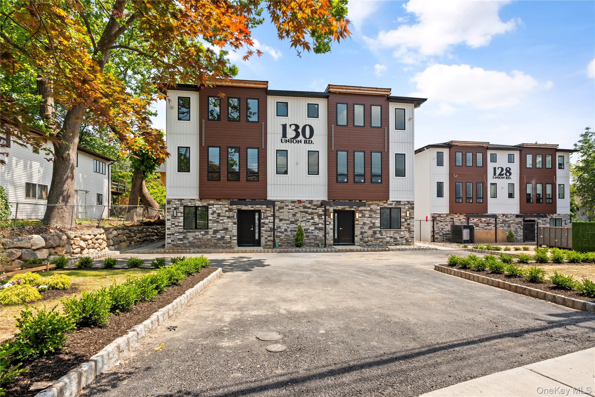 a front view of a residential apartment building with a yard