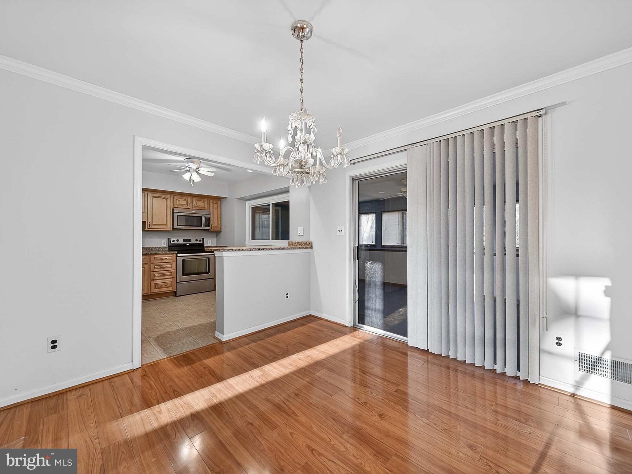 9315 Lees Ridge Road Warrenton, VA 20186 - Photo 11 of 51 a empty room with kitchen and wooden floor