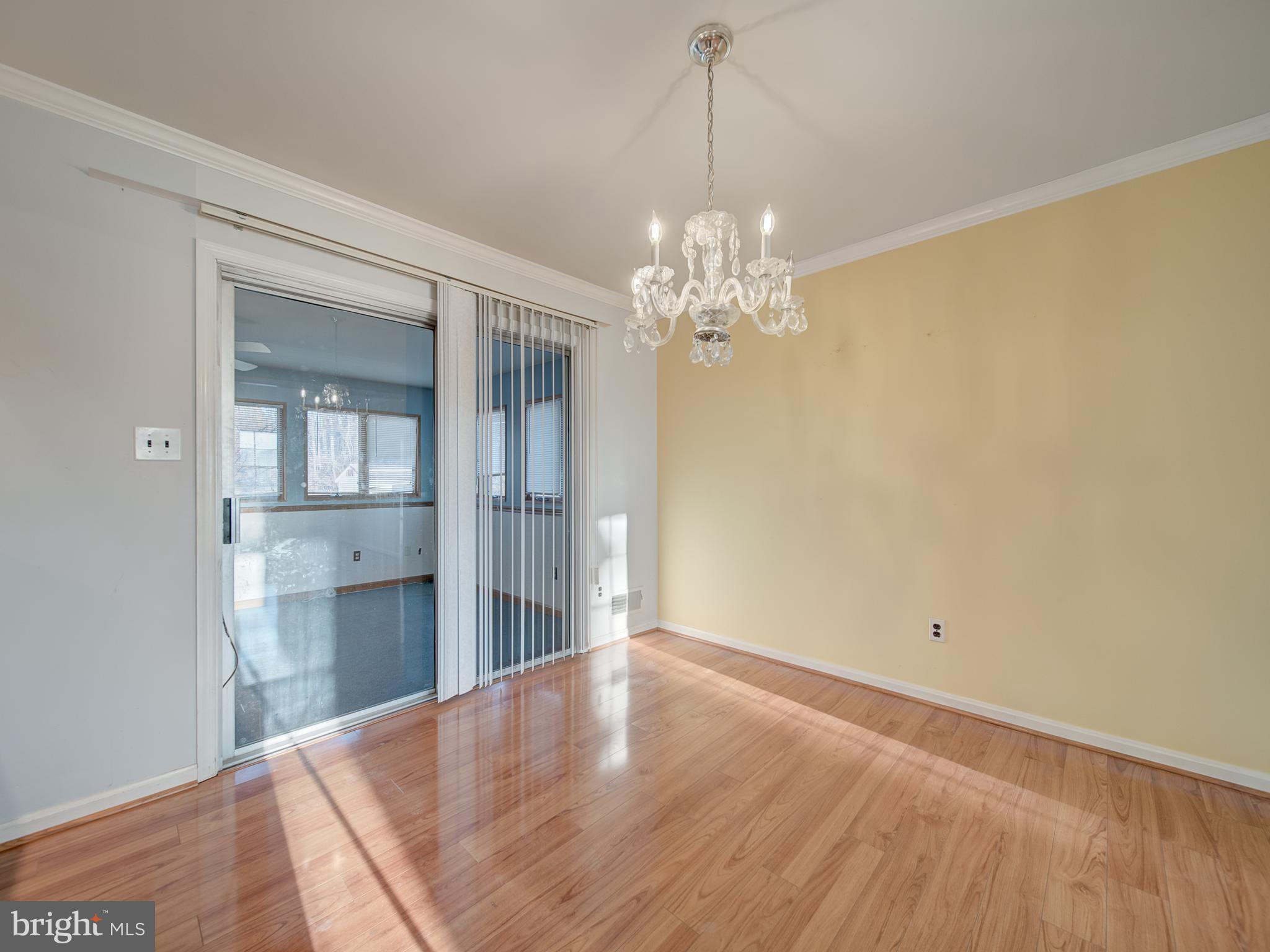 9315 Lees Ridge Road Warrenton, VA 20186 - Photo 12 of 51 a view of a hallway with wooden floor and a chandelier