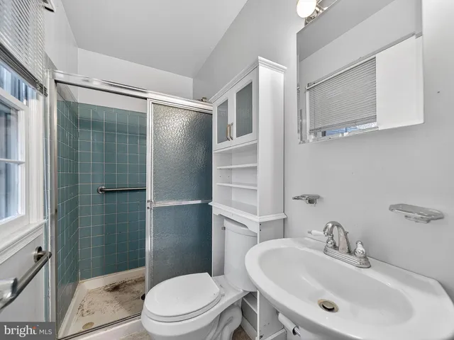 a view of an empty room with chandelier and a window
