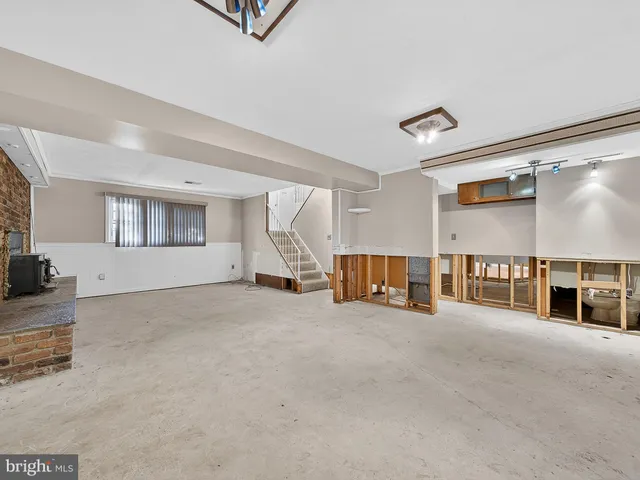 a view of empty room with a fireplace