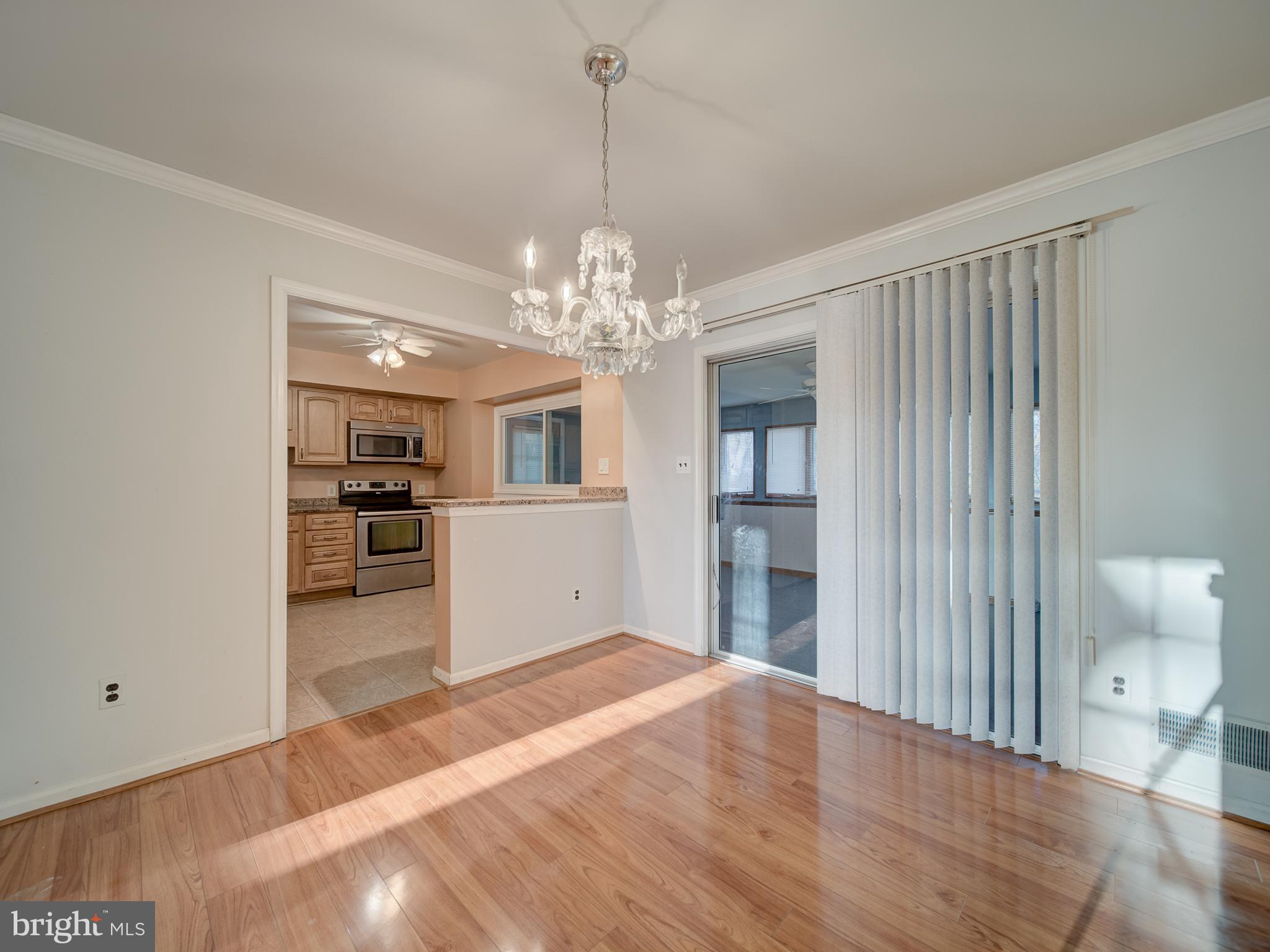 9315 Lees Ridge Road Warrenton, VA 20186 - Photo 10 of 51 a view of a livingroom with a chandelier fan and kitchen view