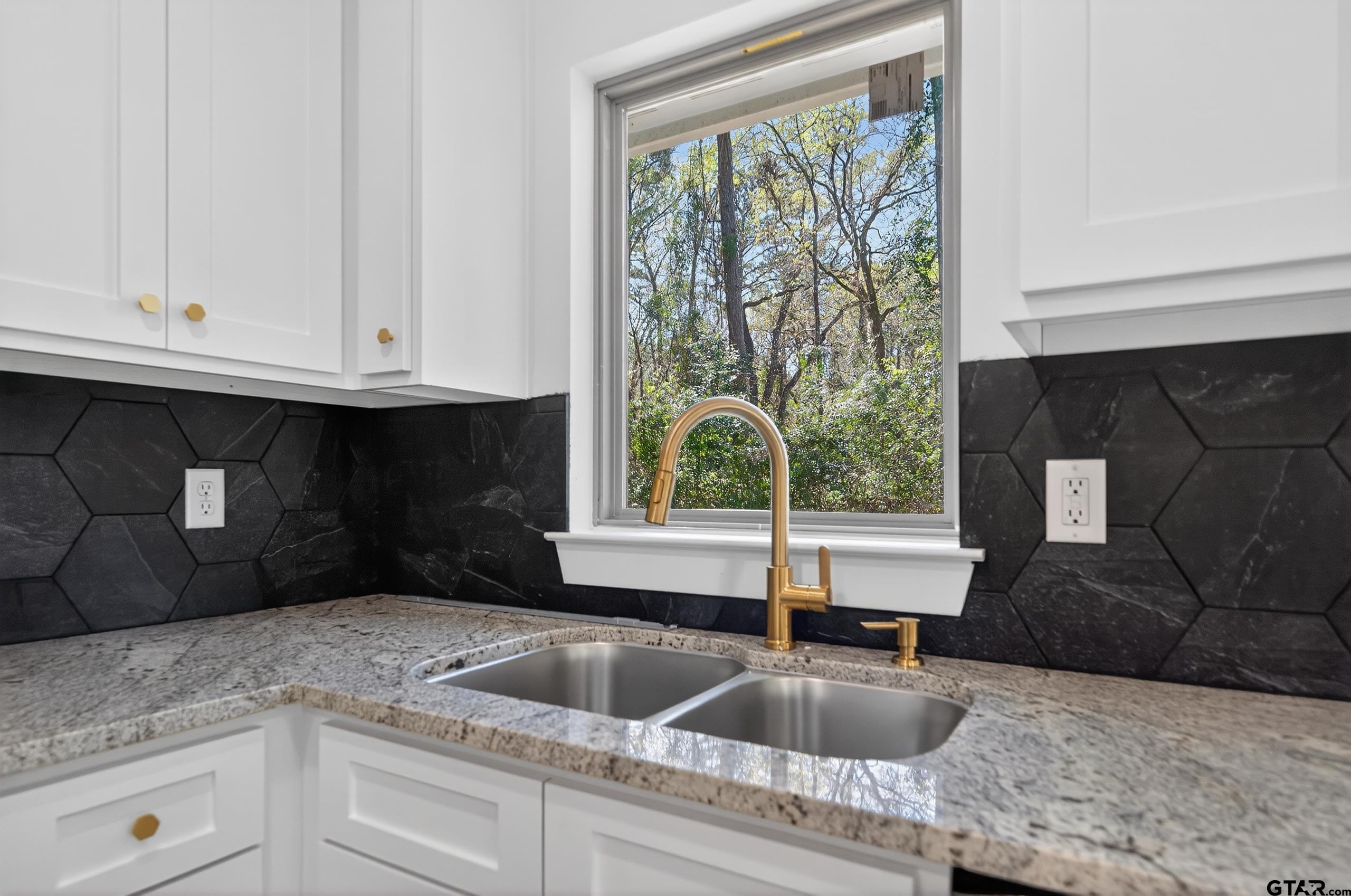 329 Wiley Drive Bullard, TX 75757 - Photo 15 of 31 a kitchen with granite countertop a sink window and cabinets
